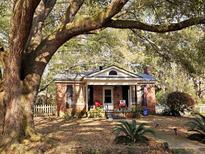 Charming brick home with mature trees and a well-manicured lawn at 306 Perry Rd, Walterboro, SC 29488