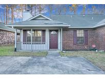 Charming single-story home with brick and vinyl siding, a covered porch, and a well-maintained front yard at 425 Miami St # A, Ladson, SC 29456