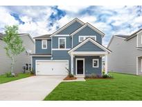 Charming two-story home features a blue exterior, well-manicured lawn, and an attached white two-car garage at 588 Red Monarch Way, Moncks Corner, SC 29461