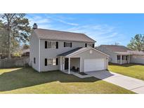 Charming two-story home with grey siding, black shutters, and an attached two-car garage at 8005 Old Hazelwood Rd, North Charleston, SC 29406