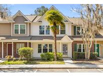 Charming townhome featuring manicured landscaping, a quaint front yard, and a welcoming entryway at 8147 Shadow Oak Dr, North Charleston, SC 29406