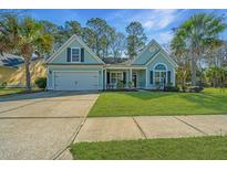 Charming home boasts a well-manicured lawn, attached garage, and lovely curb appeal with mature trees at 8502 Sentry Cir, North Charleston, SC 29420