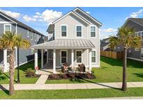 Charming two-story home with a welcoming front porch, lush lawn, and beautiful palm trees at 108 Arrowwood Way, Summerville, SC 29485