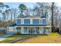 Beautiful two-story home with a classic front porch and a spacious yard at 115 Laurel Ridge Rd, North Charleston, SC 29418
