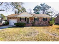 Charming brick home with manicured lawn and attached garage, creating instant curb appeal at 117 Loblolly Ln, Summerville, SC 29483