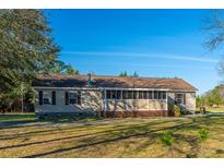 Charming single-story home with a screened-in porch and well-maintained yard at 165 Infinity Dr, Dorchester, SC 29437