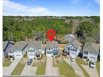 Charming two-story home with a spacious driveway, surrounded by lush greenery, in a peaceful neighborhood at 1800 Poplar Grove Pl, Summerville, SC 29483