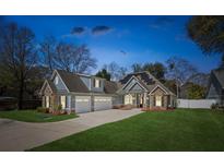 Charming two-story home with stone accents, a three-car garage, and well-maintained landscaping at 1874 Rifle Range Rd, Mount Pleasant, SC 29464