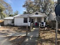 Exterior view of a one-story home with a ramp leading to the front porch and small lawn at 1907 Helm Ave, North Charleston, SC 29405