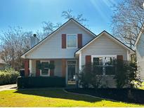 Charming single-story home with a well-manicured lawn, red shutters, and inviting front porch at 2433 Fulford Ct, Mount Pleasant, SC 29466