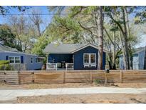 Charming blue single-story home with a welcoming front porch and tasteful landscaping at 2758 W Surrey Dr, North Charleston, SC 29405
