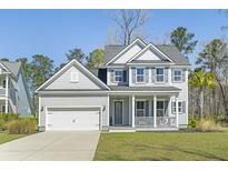 Charming two-story home features a classic design, attached garage and a welcoming front porch at 2763 Summertime Ln, Mount Pleasant, SC 29466