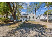 Charming one-story home with a small porch, grey siding and a gravel yard at 2925 Alabama Dr, North Charleston, SC 29405
