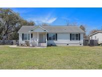 Charming single-story home with black shutters and a well-maintained front yard at 3075 Old Highway 52, Moncks Corner, SC 29461