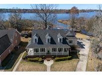 Inviting waterfront home with a charming front porch and well-manicured landscaping at 318 Archibald Dr, Goose Creek, SC 29445