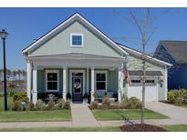 Charming single-Gathering home with a cozy front porch, pristine landscaping, and a two-car garage at 3522 Habenaria Rd, Mount Pleasant, SC 29466
