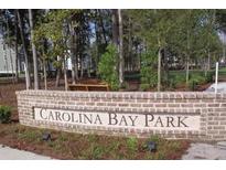 Carolina Bay Park brick signage amongst trees, shrubs, and green space at 4021 Flatiron Dr, Charleston, SC 29414