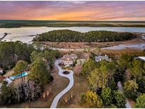 Stunning aerial view of estate home, winding driveway and waterfront location at 4051 Colonel Vanderhorst Cir, Mount Pleasant, SC 29466