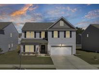 Charming two-story home with light siding, a well-manicured lawn, and a two-car garage at 522 Killdeer Rd, Summerville, SC 29486