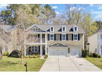 Charming two-story home with a well-manicured lawn, three dormer windows, and a wide driveway leading to a two-car garage at 5409 Clairmont Ln, North Charleston, SC 29420