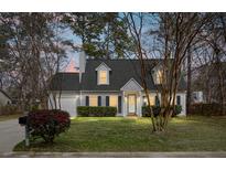 Charming two-story home featuring manicured lawn, inviting entryway, and attached garage at 8458 William Moultrie Dr, North Charleston, SC 29420