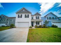 Charming two-story home featuring a well-manicured lawn and a classic white exterior, perfect for suburban living at 107 Goose Rd, Summerville, SC 29483