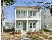 Charming two-story home with a double-porch, light blue siding, and landscaped front yard at 114 E Respite Ln, Summerville, SC 29483
