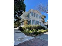 Charming two-story home featuring a spacious porch and beautiful blue shutters at 115 Rutledge Ave # A, Charleston, SC 29401