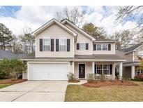 Charming two-story home with attached garage, black shutters, and welcoming front porch at 122 Moon Shadow Ln, Summerville, SC 29485