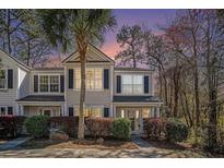 Charming townhome featuring a well-maintained lawn and complemented by a beautiful sunset backdrop at 1271 Island Club Dr # B, Charleston, SC 29492