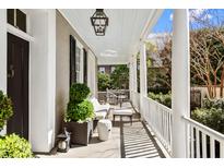 Inviting front porch offers comfortable seating and relaxing views of the charming neighborhood at 34 Anson St, Charleston, SC 29401