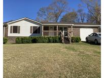Charming single-story home with brick and vinyl siding and a covered front porch at 391 Furman Ln, Ladson, SC 29456