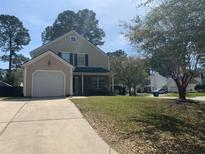 Charming two-story home with a well-manicured lawn and attached one car garage at 4800 Wheatfield Dr, Summerville, SC 29485
