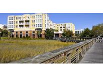Yellow condo building exterior featuring balconies and a wooden walkway at 5009 Old Bridgeview Ln # 5009, Charleston, SC 29403