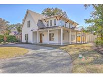 Beautiful two-story home with white siding, wood accents, and a welcoming front porch at 755 Adluh St, Mount Pleasant, SC 29464