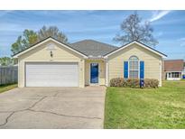 Charming single-story home featuring a well-manicured lawn and attached one car garage at 8405 Wylie Dr, North Charleston, SC 29406