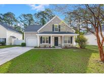 Charming single-Gathering home featuring well-manicured lawn, tidy landscaping, and attached garage on a sunny day at 9116 Fieldstone Trace, Summerville, SC 29485