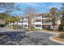 Inviting condo complex featuring well-maintained landscaping, ample parking, and screened in porches on each level at 1025 Riverland Woods Pl # 609, Charleston, SC 29412