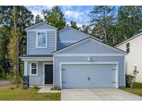 Charming two-story home with a two-car garage and light blue siding at 111 Vistawood Dr, Charleston, SC 29414