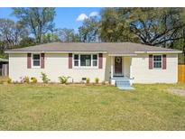 Charming single-story home with a well-maintained lawn, fresh landscaping, and appealing curb appeal at 1526 Chandler St, Charleston, SC 29412