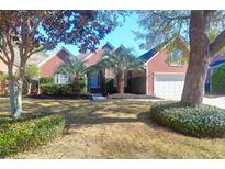Charming brick home featuring mature trees, a manicured lawn, and an attached two car garage at 2707 Waterpointe Cir, Mount Pleasant, SC 29466