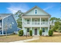 Charming two-story home with a welcoming double porch, complemented by lush landscaping at 2917 Swamp Sparrow Cir, Johns Island, SC 29455
