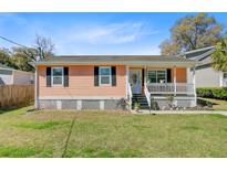 Charming one-story home with an inviting front porch and well-maintained lawn at 679 Kent St, Mount Pleasant, SC 29464