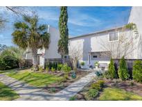 Charming townhome featuring a well-maintained lawn, lovely landscaping, and a welcoming front walkway at 1103 Ventura Pl, Mount Pleasant, SC 29464