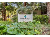 Summer Wind Cottages sign surrounded by lush, green landscaping at 1153 Summerwind Ln, Seabrook Island, SC 29455