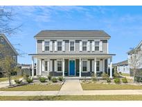 Charming two-story home featuring a welcoming front porch and a vibrant blue front door at 123 Hewitt St, Summerville, SC 29486