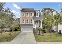 Charming two-story home featuring a welcoming entrance, attached garage, and beautifully landscaped front yard at 1428 Bloomingdale Ln, Mount Pleasant, SC 29466