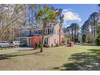 Charming two-story home with a well-manicured front yard and mature trees, perfect for suburban living at 1807 Chauncy'S Ct, Mount Pleasant, SC 29466