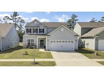 Charming two-story home with a well-manicured lawn, two-car garage, and welcoming curb appeal at 203 Hayworth Rd, Summerville, SC 29486