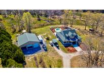 Sprawling property featuring a home with a pool, large garage, and several vehicles parked on the grounds at 212 Chester Ln, Cottageville, SC 29435